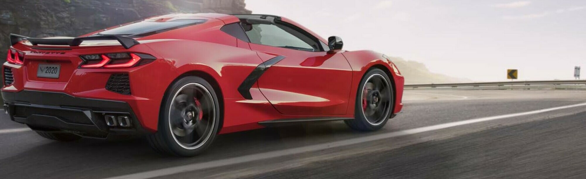 Red 2020 C8 Corvette convertible driving down road