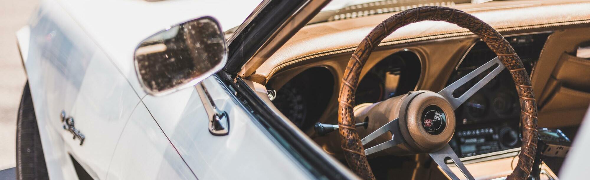 White C3 Corvette Stingray with custom brown steering wheel and interior