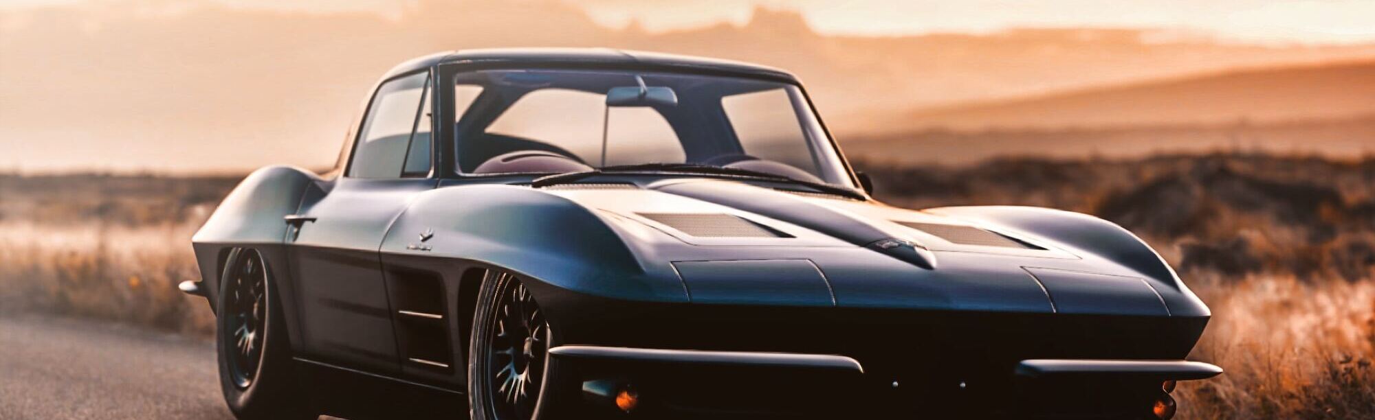 Black modified C2 Corvette during sunset